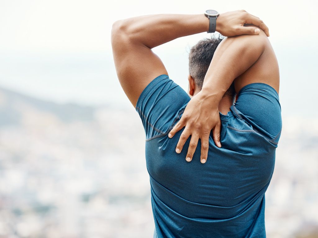 Adult stretching shoulders to illustrate age-related changes in physical recovery