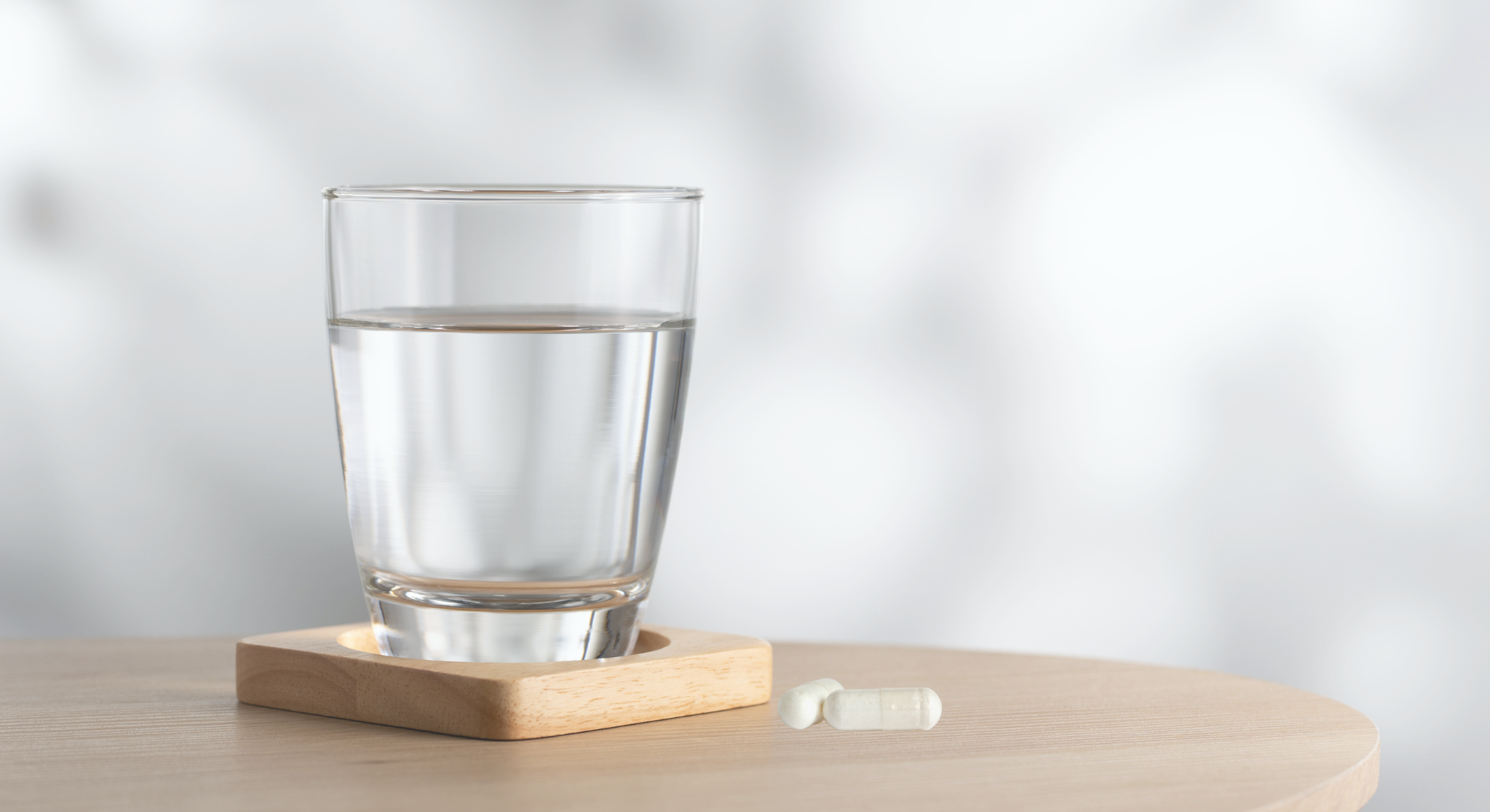 Supplement capsule beside a glass of water, representing a pulsed protocol day.